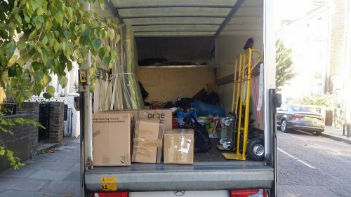 Enclosed skip being loaded in Mayfair